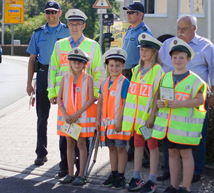 Children in safety vest to learn the traffic laws